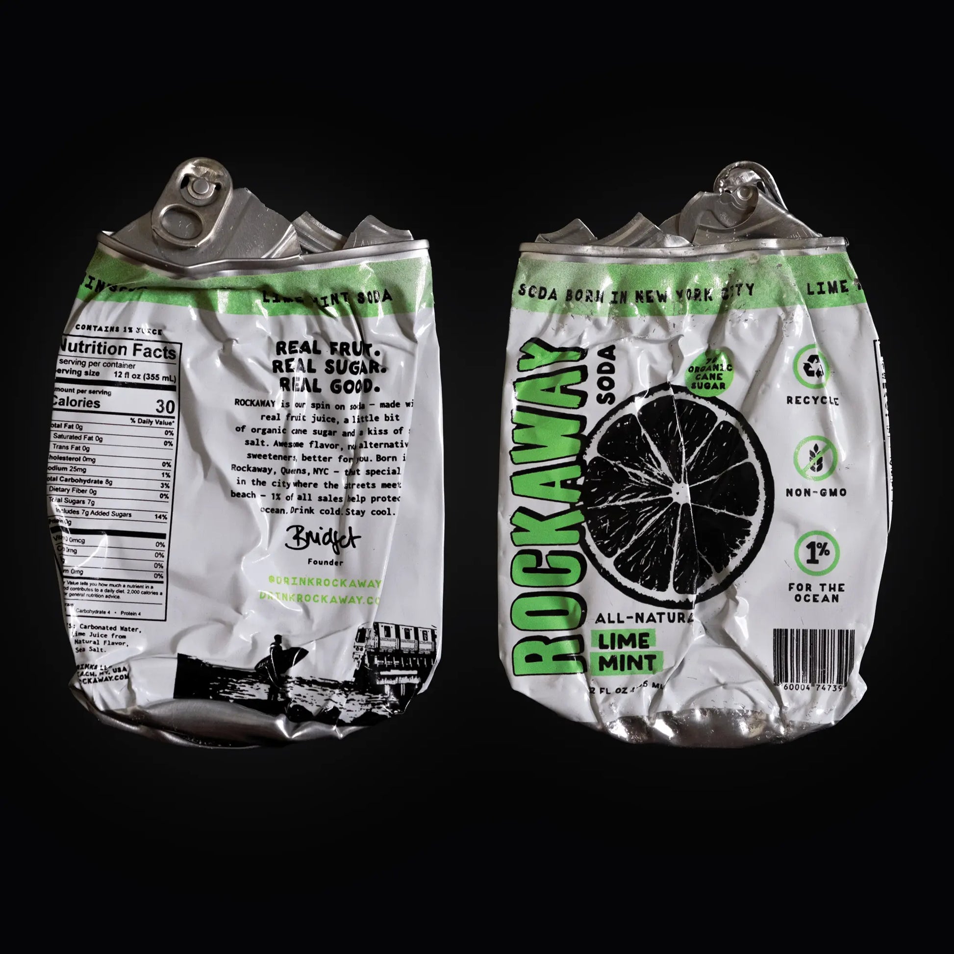 Two crushed Rockaway Soda lime mint cans on a black background